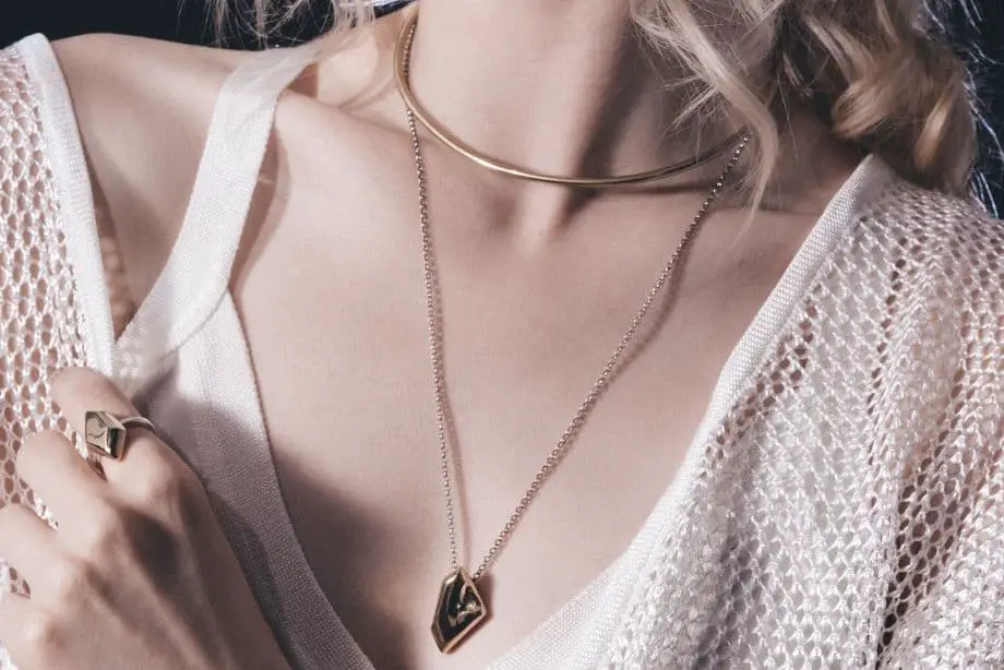 Woman Wearing Gold Filled Jewelry Pieces Like Rings, Necklaces, Earrings, and Bracelets